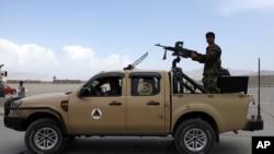 FILE - Afghan army soldiers patrol after the American military left Bagram air base, in Parwan province north of Kabul, Afghanistan, July 5, 2021. 