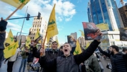 Youth celebrate carrying pictures of slain Hezbollah leader Hassan Nasrallah and the party's flags in Dahiyeh, Beirut, Lebanon, following a ceasefire between Israel and Hezbollah that went into effect on WNov. 27, 2024. 