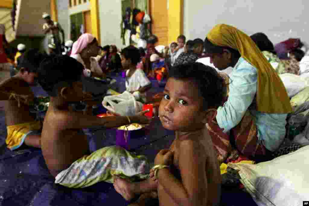 Seorang anak dari etnis Rohingya makan di dalam tempat penampungan setelah diselamatkan, bersama dengan ratusan lainnya dari kapal, di Lhoksukon, Aceh (12/5).&nbsp;​(Reuters/Roni Bintang)