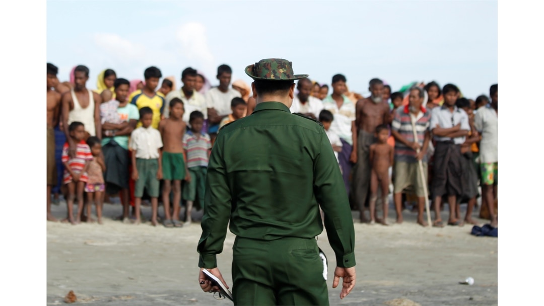 FILE - Rohingya Muslims wait to cross the border to Bangladesh, in a temporary camp outside Maungdaw, northern Rakhine state, Myanmar, Nov. 12, 2017.