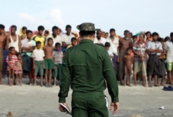 FILE - Rohingya Muslims wait to cross the border to Bangladesh, in a temporary camp outside Maungdaw, northern Rakhine state, Myanmar, Nov. 12, 2017.