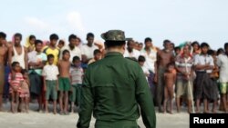 FILE - Rohingya Muslims wait to cross the border to Bangladesh, in a temporary camp outside Maungdaw, northern Rakhine state, Myanmar, Nov. 12, 2017. 