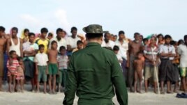 FILE - Rohingya Muslims wait to cross the border to Bangladesh, in a temporary camp outside Maungdaw, northern Rakhine state, Myanmar, Nov. 12, 2017.