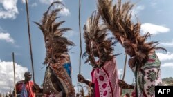 FILE - Young Maasai men wearing a ceremonial headdress made of ostrich feathers parade at the ceremonial site during the Eunoto ceremony in a remote area near Kilgoris, Kenya on August 18, 2023.