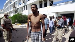 Gaddafi loyalists, taken prisoner by anti-Gaddafi fighters, are led out after they were found hiding in a hospital in the center of Sirte, October 9, 2011.