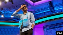 FILE - Shourav Dasari, 13, of Spring, Texas, pauses during the morning round of the finals of the 2016 Scripps National Spelling Bee, at National Harbor in Oxon Hill, Md., May 26, 2016.