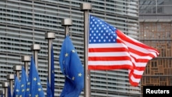 FILE - A U.S. and European Union flags are pictured during the visit of Vice President Mike Pence to European Commission headquarters in Brussels, Belgium, Feb. 20, 2017.