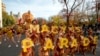 FILE - Dancers wearing face masks and dressed as Thanksgiving turkeys hold letters that spell Macy's Parade in New York City at the front of the Macy's Thanksgiving Parade on Thursday, Nov. 25, 2021. 