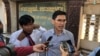 Former Radio Free Asia reporters Uon Chhin (left) and Yeang Sothearin talk to reporters outside of the appeals court on December 23, 2019. (Tum Malis/VOA Khmer)