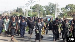 In this file photo, hundreds of women march through the streets to protest the killing of women and children and destruction of properties in Jos, Plateau State in central Nigeria. Hundreds of people have been killed in ethnic clashes in the area in recen