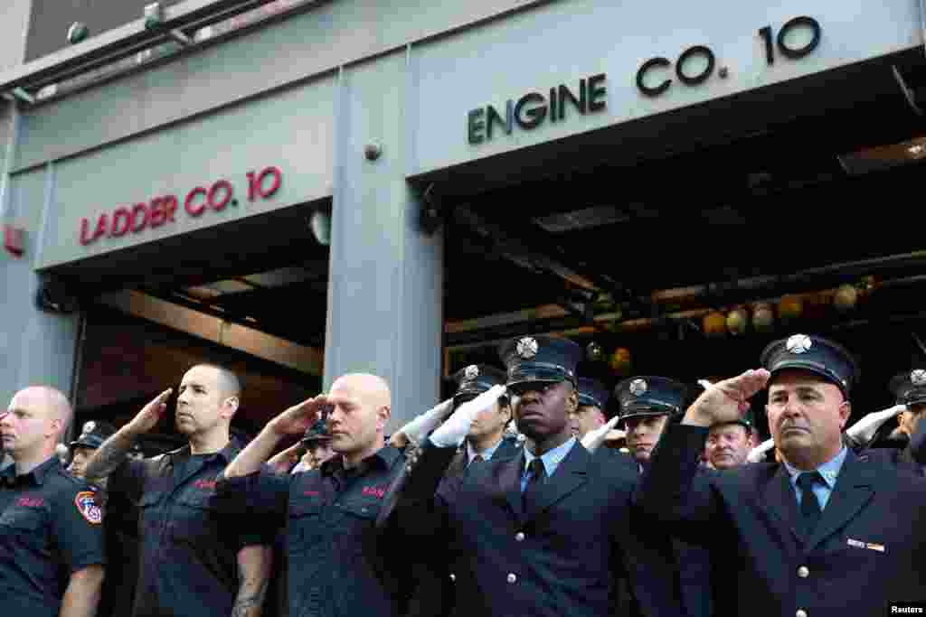 New York City Fire Department (FDNY) firefighters salute near the World Trade Center site on the 18th anniversary of the 9/11 attacks in lower Manhattan in New York, Sept. 11, 2019.