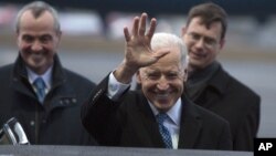 U.S. Vice President Joe Biden, center, waves to the media upon arrival at the Tegel airport in Berlin, Germany, Feb. 1, 2013. In the background left is U.S. ambassador to Germany Philip D. Murphy.