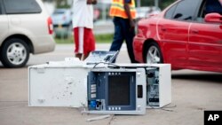 Passers-by take a closer look Aug. 11, 2014, at the ATM that was removed and opened after violence erupted overnight in Ferguson, Missouri, following a candle-light memorial for shooting victim Michael Brown, 18.