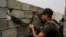 FILE - A soldier with the Iraqi special forces reloads his weapon on a rooftop in west Mosul as fighting between Iraqi troops and the Islamic State group continues, April 23, 2017.