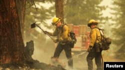 Firefighters manage the burn of the Dixie Fire near Chester, Calif., Aug. 13, 2021. 