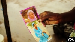 Esther Yakubu menunjukkan gambar putrinya, Dorcas Yakubu, gadis suku Chibok yang tampil di video Boko Haram, yang dirilis di Abuja, Nigeria, 13 Agustus 2016. (C. Oduah/VOA)