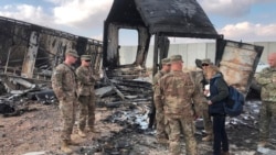 FILE - U.S. soldiers stand amid damage at a site of Iranian bombing at Ain al-Asad air base, in Anbar, Iraq, Jan. 13, 2020.