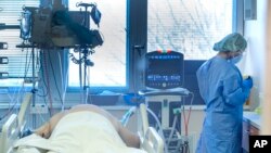 Medical staff attend to a patient at the COVID-19 ICU unit of the hospital in Bratislava, Slovakia, Nov. 23, 2021. 