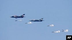 FILE - Myanmar Air Force Jet fighters drop bombs during military exercises Friday, Feb. 2, 2018, in Ayeyarwaddy delta region, Myanmar. (Lynn Bo Bo/Pool via AP, File)