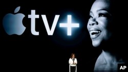 FILE - Oprah Winfrey speaks at the Steve Jobs Theater during an event to announce new Apple products, in Cupertino, California, March 25, 2019.