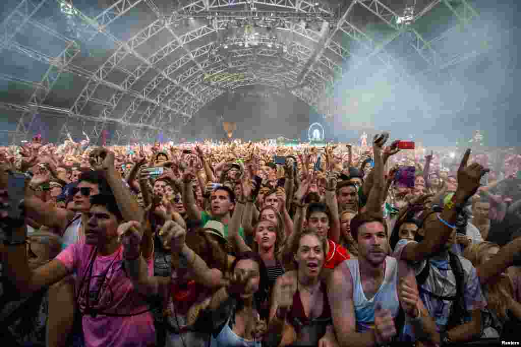 Fans listen to David Guetta at the Coachella Valley Music and Arts Festival in Indio, California, April 12, 2015.