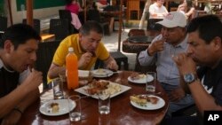 Custumers eat guinea pig at a restaurant in Lima, Peru, Oct. 3, 2024. 