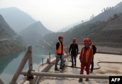 FILE - This photograph taken Oct. 31, 2017, shows Chinese engineers working on the Neelum-Jhelum Hydropower Project in Nosari, in Pakistan-administered Kashmir's Neelum Valley.