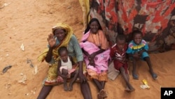 Photo released by the United Nations African Union Mission in Darfur (UNAMID) shows women and their children outside their tents at the Zam Zam refugee camp for internally displaced people (IDP) in North Darfur, Sudan, June 11, 2014.