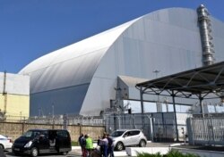 FILE - This June 1, 2019, file photo shows a view of the New Safe Confinement (NSC) movable enclosure at the nuclear power plant in Chernobyl, Ukraine.