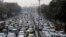 FILE - Vehicles move slowly at a traffic intersection after the end of a two-week experiment to reduce the number of cars to fight pollution in in New Delhi, India, Jan. 16, 2016. 