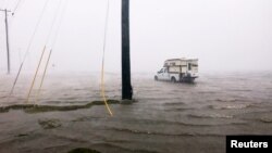 A truck is seen stuck in flood waters as Hurricane Harvey comes ashore in Corpus Christi, Texas, Aug. 25, 2017.