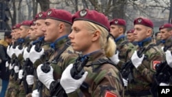 FILE - Members of the police forces of Republic of Srpska march during a parade marking the 26th anniversary of the Republic of Srpska in the Bosnian town of Banja Luka, Jan. 9, 2018. The January 9 holiday commemorates the date in 1992 when Bosnian Serbs declared the creation of their own state in Bosnia, igniting the country's four-year war.