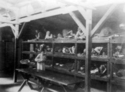 FILE: Inmates are seen lying on bunks in a barrack at Nazi German death camp Auschwitz-Birkenau after its liberation in 1945, in this undated handout picture obtained by Reuters, Jan. 19, 2020. (Courtesy of Yad Vashem Archives)