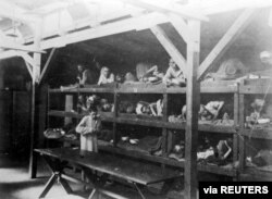 FILE: Inmates are seen lying on bunks in a barrack at Nazi German death camp Auschwitz-Birkenau in this undated handout picture obtained by Reuters, Jan. 19, 2020. (Courtesy of Yad Vashem Archives)