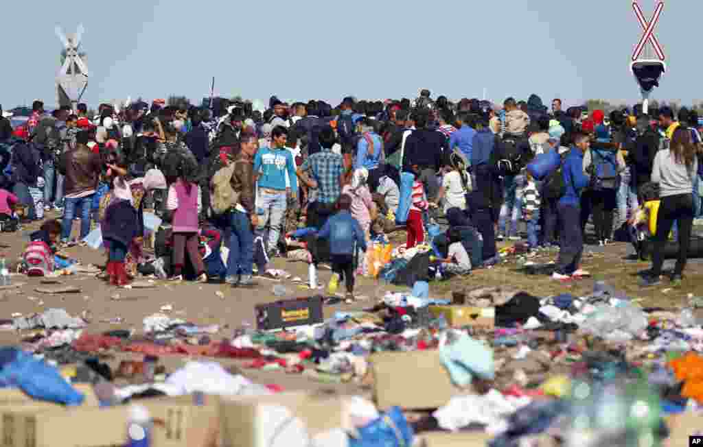 They gather at the railway track in a camp near the Hungarian border with Serbia, in Roszke. Leaders of the United Nations refugee agency warn that Hungary faces a bigger wave of migrants in the next few days and will need international help to provide aid and shelter on its border.