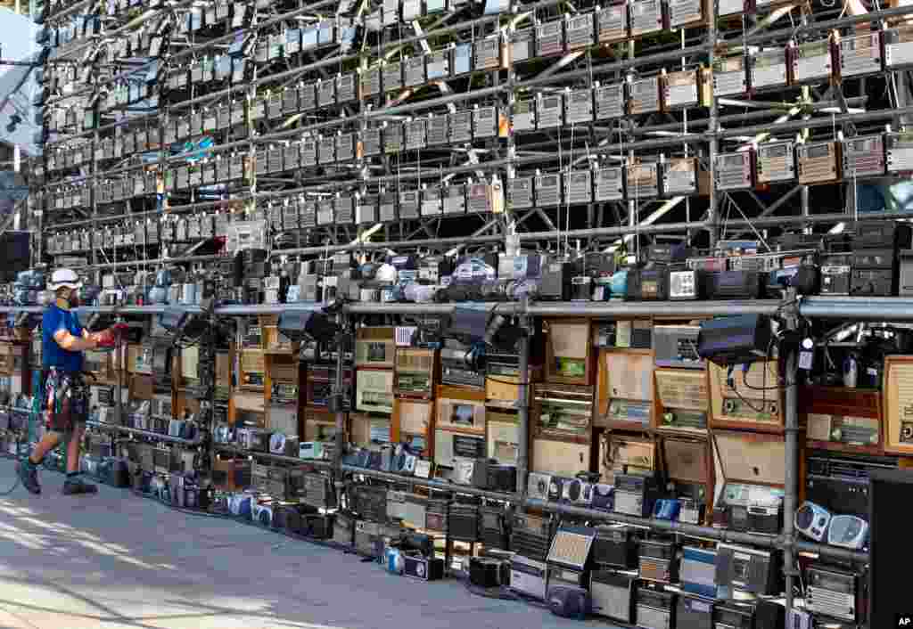 A technician prepares a giant construction made up of nearly 1,500 old radios on Vilnius Cathedral square, to commemorate events of 1989 when analog radios were used to coordinate so-called Baltic Way human chain, in Vilnius, Lithuania.