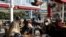 Women chat as they wait to be served at a restaurant reopened for business in Ankara, Turkey, March 2, 2021, as cafes, restaurants and other eateries reopened in some provinces across the country.