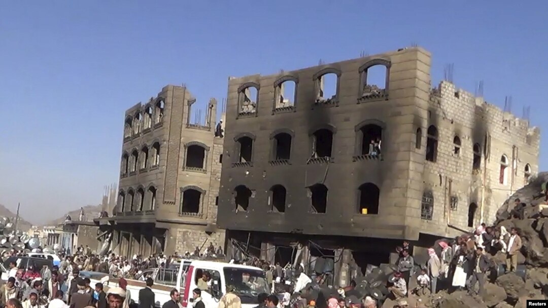 FILE - People gather at the site of an airstrike by the Saudi-led coaltion in Yareem city in Ibb province, Yemen, March 31, 2015. 