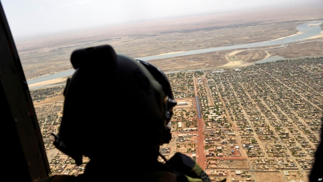 FILE - A French soldier stands inside a military helicopter during a visit by French President Emmanuel Macron to the troops of Operation Barkhane, May 19, 2017.