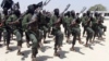 FILE - Al-Shabab fighters march during military exercises in the Lafofe area, 18 kilometers south of Mogadishu, Somalia, Feb. 17, 2011.