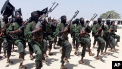 FILE - Al-Shabab fighters march during military exercises in the Lafofe area, some 18 kilometers (11 miles) south of Mogadishu, Somalia, Feb. 17, 2011.