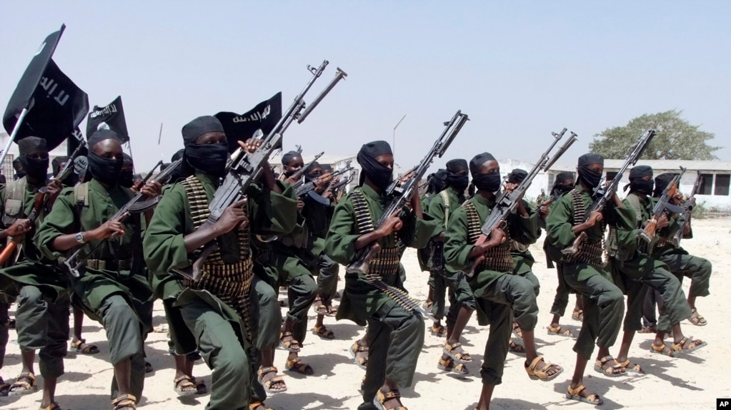 FILE - Al-Shabab fighters march during military exercises in the Lafofe area, some 18 kilometers (11 miles) south of Mogadishu, Somalia, Feb. 17, 2011.