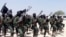 FILE - Hundreds of newly trained al-Shabab fighters perform military exercises in the Lafofe area some 18 km south of Mogadishu, in Somalia, Feb. 17, 2011. 