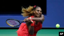 Serena Williams, of the United States, returns a shot to Kristie Ahn, of the United States, during the first round of the US Open tennis championships, Sept. 1, 2020, in New York.