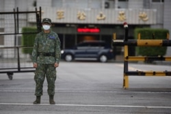 Soldier wears a mask against COVID-19 outside military airbase in Taipei, Taiwan, Aug. 10, 2020.