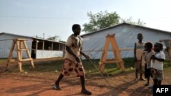 Un garçon joue à l'extérieur des tentes utilisées comme salles de classe temporaires, sur le site de déplacées, au Grand Séminaire Saint-Marc à Bimbo, au sud-ouest de Bangui, 6 février 2014.