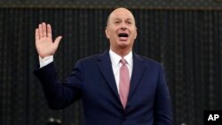 U.S. Ambassador to the European Union Gordon Sondland is sworn in to testify before the House Intelligence Committee on Capitol Hill in Washington, Nov. 20, 2019, during a public impeachment hearing of President Donald Trump.