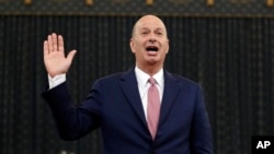 U.S. Ambassador to the European Union Gordon Sondland is sworn in to testify before the House Intelligence Committee on Capitol Hill in Washington, Nov. 20, 2019, during a public impeachment hearing of President Donald Trump.