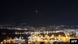 Rockets fired from southern Lebanon are intercepted by Israel's Iron Dome air defence system as seen from Haifa in northern Israel, on September 24, 2024.