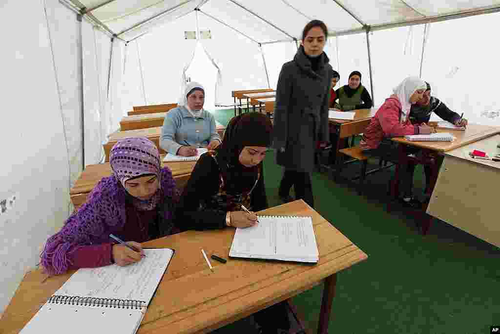 Syrian girls attend a class in a makeshift classroom at the Boynuyogun refugee camp on the Turkish-Syrian border in Hatay province February 8, 2012. (Reuters)